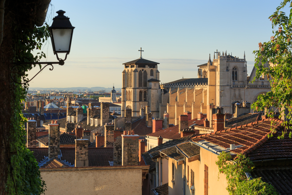 View over buildings with an old lamp  at golden hour in the Old Lyon quarter.