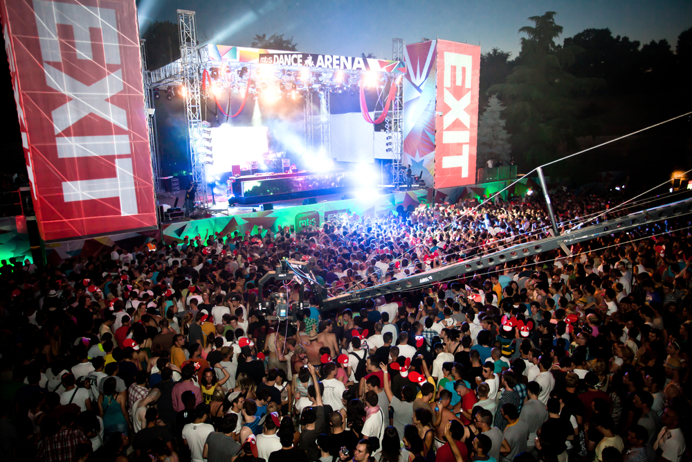 a large crowd in front of a stage at an music festival in Europe 