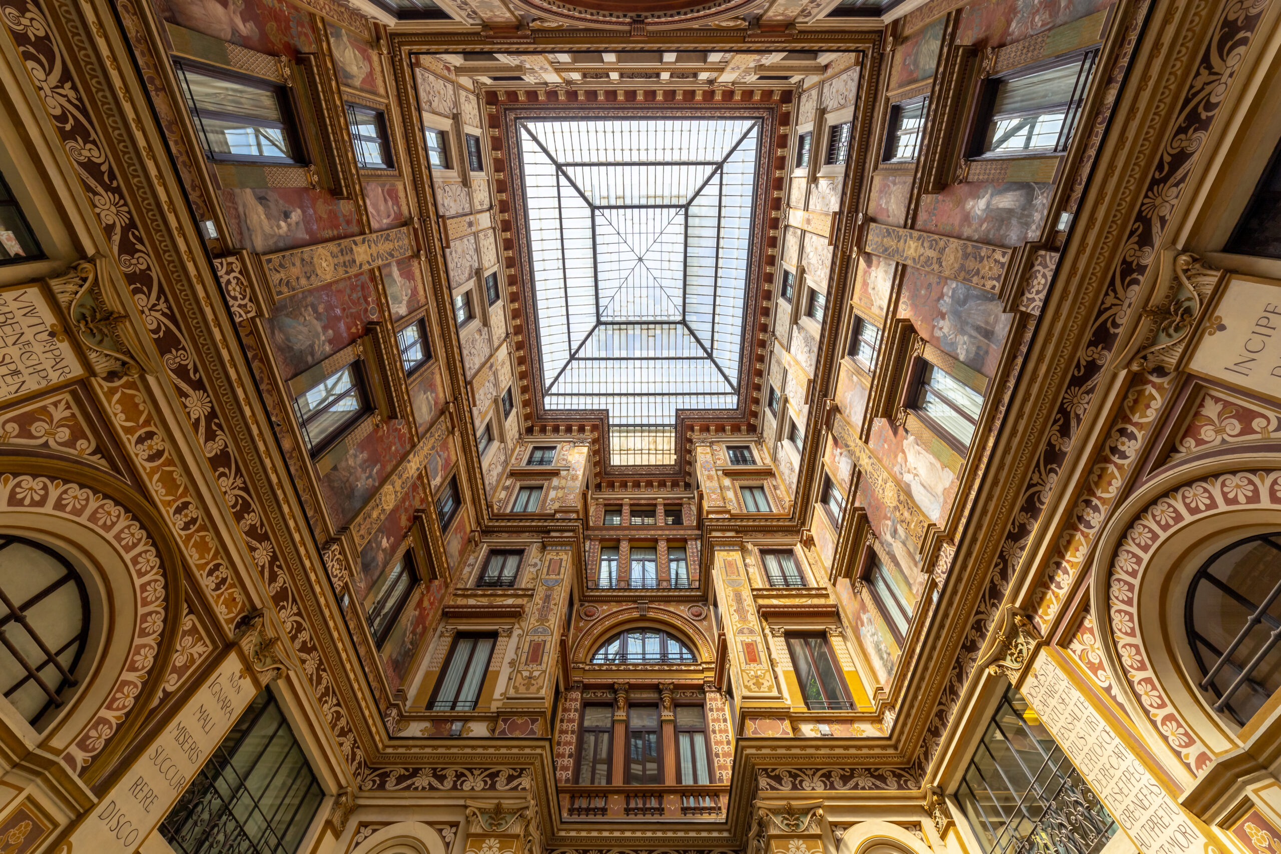 View of the golden interior of Galleria Sciarra 