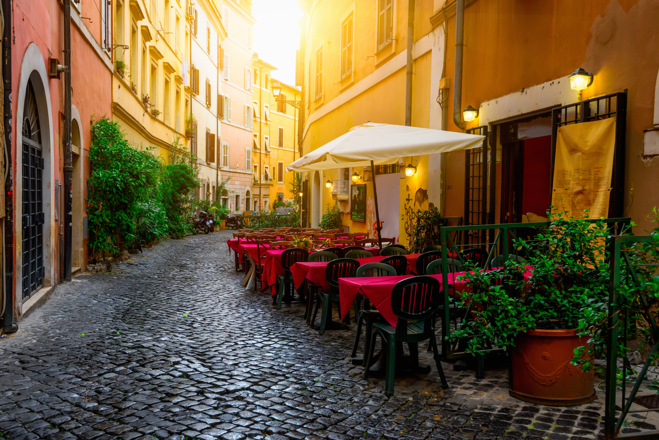 Scene of a picturesque outdoor dining area on the cobbled streets of Trastevere
