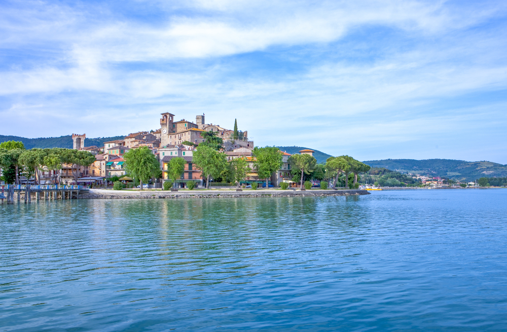 Trasimeno Lake taken from the water. you can see the town and mountains in the background. One of the lakes in Italy. 