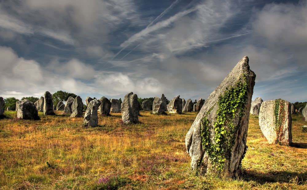 Lanscape Prehistoric Stones of Carnac with an atmospheric sky. 