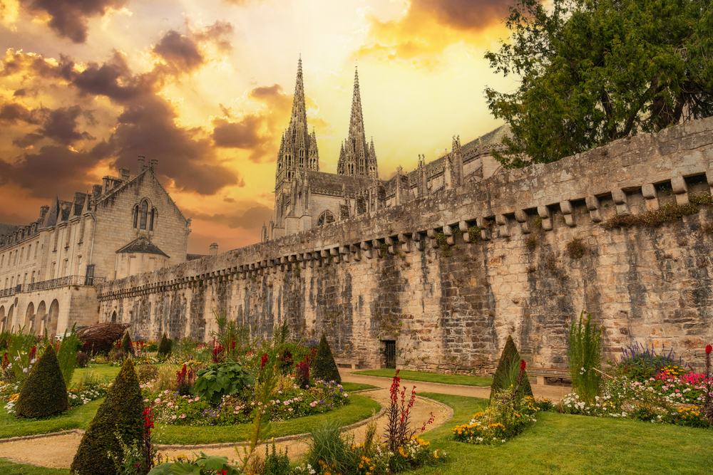 Sunset on the walls of the medieval town of Quimper and the cathedral of Saint Corentin. One of the places in northern France. 