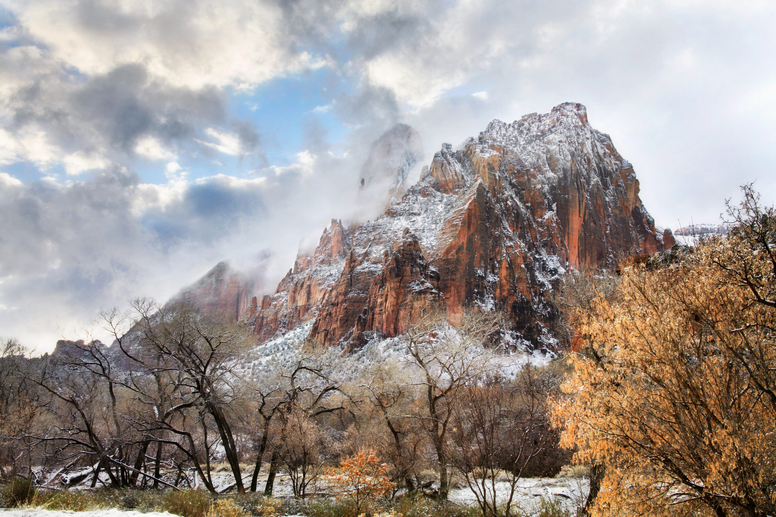 View of a snow dusted red mountain peak in winter at Zion National Park 