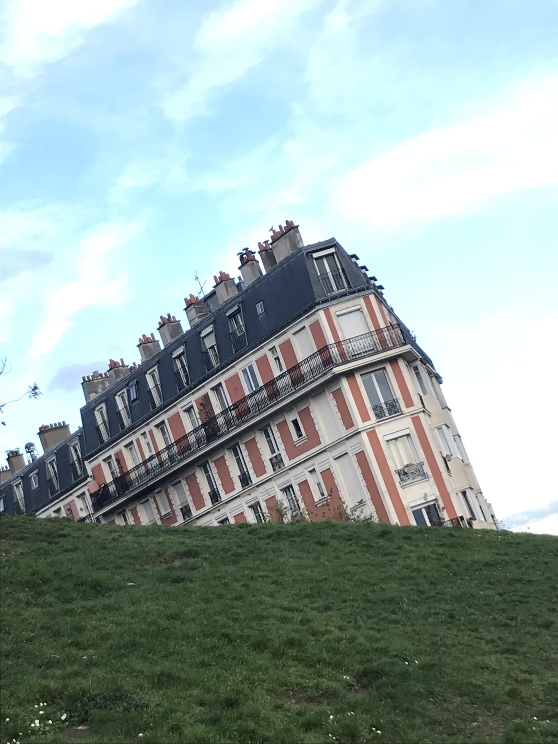 The illusion that makes it look like a house is sinking into the groud from a grassy bank. 