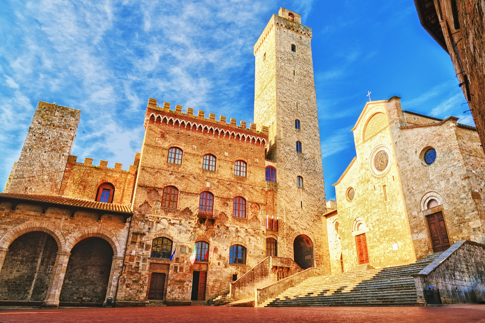 Picturesque View of famous Piazza del Duomo in San Gimignano at sunset, Tuscany, Italy. One of the things to do in Tuscany. 