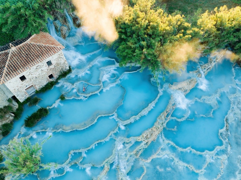 View from above, stunning aerial view of Le Cascate del Mulino, a group of beautiful hot springs in the municipality of Manciano. It is one of the things to do in Tuscany. 
