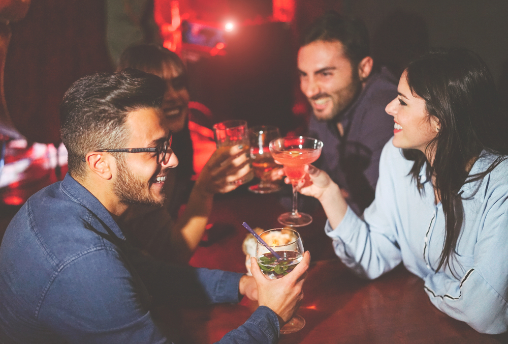 a group of friends enjoying cocktails out a bar in London