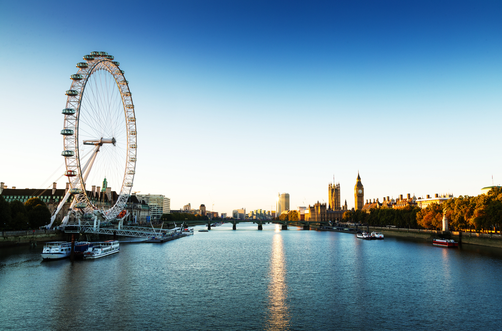 the "Ferris wheel" london eye on the left side off the Thames overlooking the river 