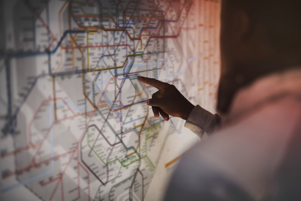 a man checking stop on a map of the London underground 