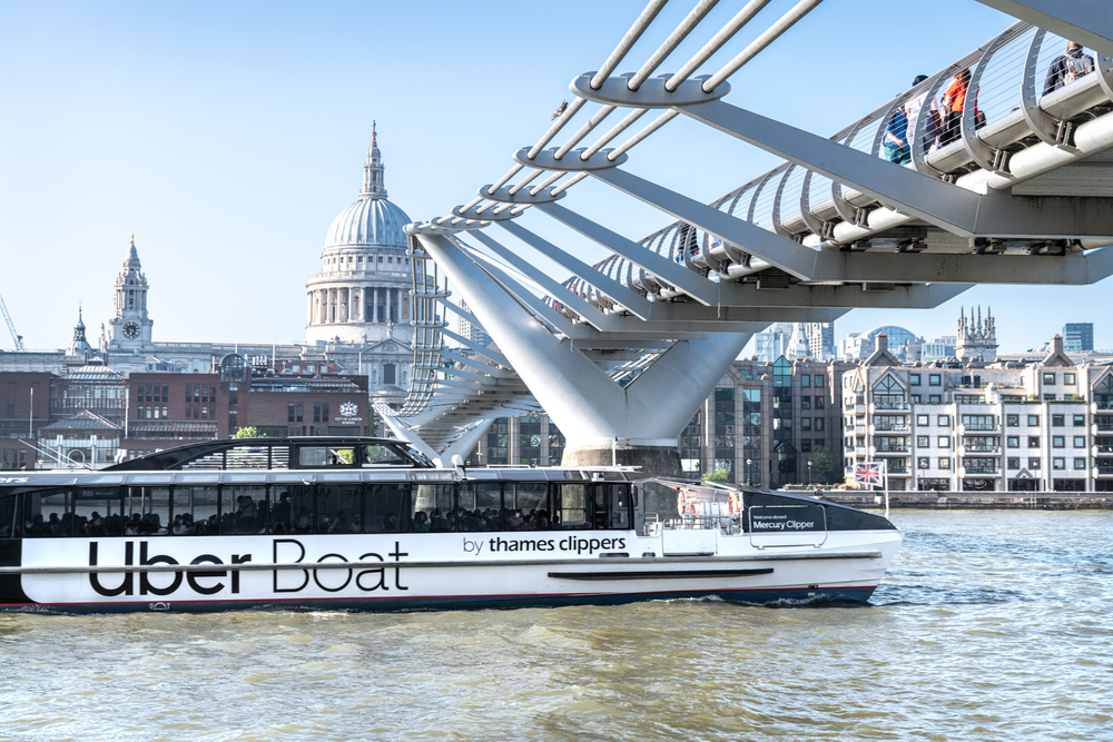 The Uber Boat thames clipper crossing under the Millenium bridge