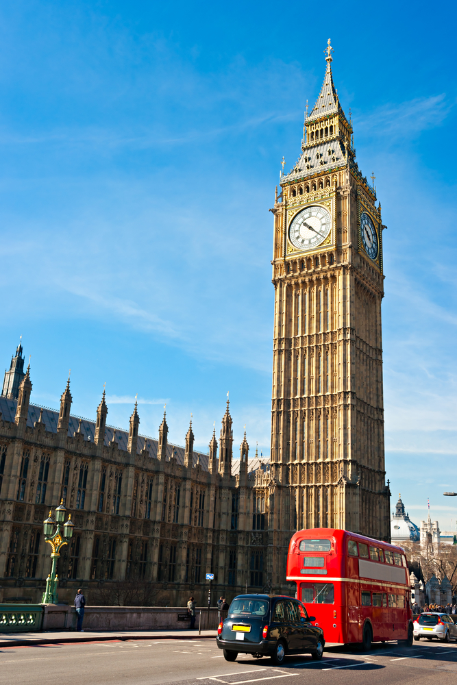 Big Ben, with a double-decker red bus passing by, is one of the iconic London sights you must see with 4 days in London