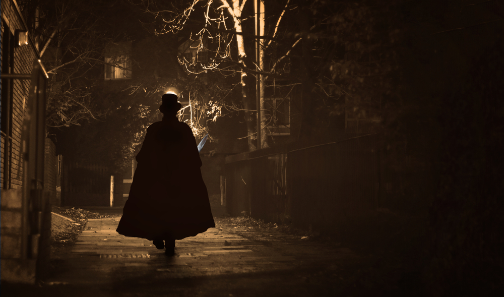 a Jack the Ripper Figure at night in London as you learn about he dark history of London