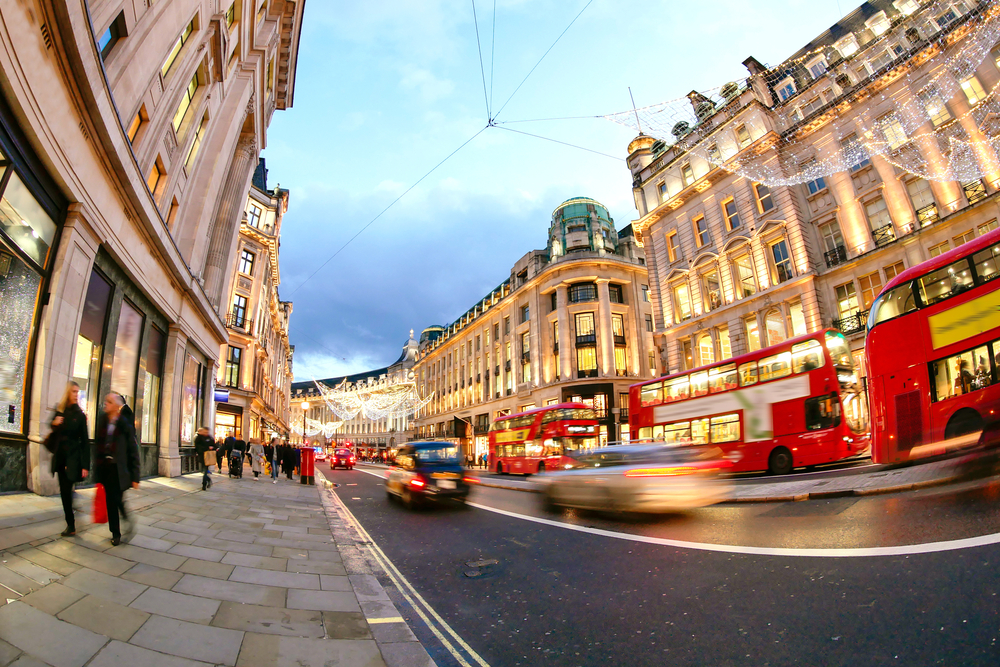 Oxford street in West End at nighttime with big red bus