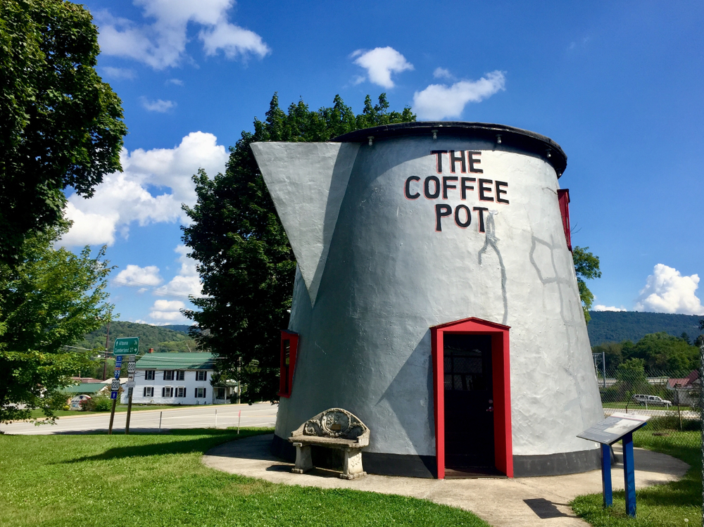Sunny day over a giant Coffee Pot with an open door on an East Coast road trip.