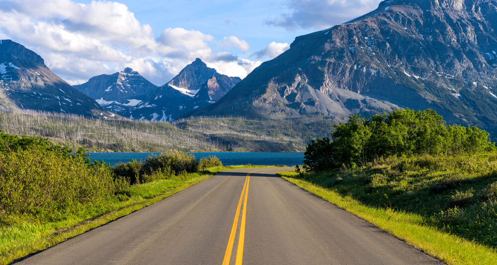 Going-to-the-Sun Road heading toward a lake and mountains on a Montana road trip.