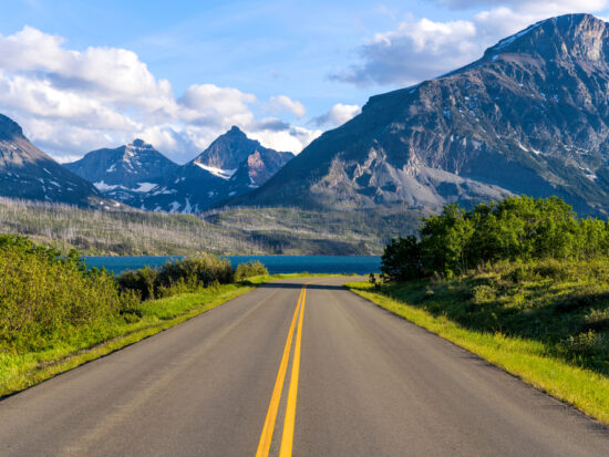 Going-to-the-Sun Road heading toward a lake and mountains on a Montana road trip.