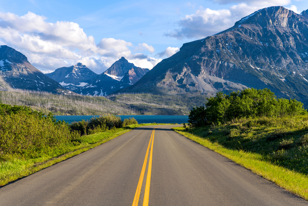 Going-to-the-Sun Road heading toward a lake and mountains on a Montana road trip.