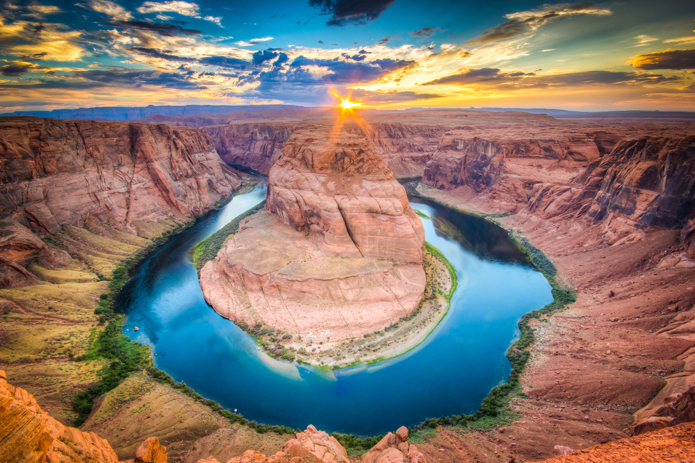 Vivid sunset over Horseshoe Bend, a river in a rugged canyon.