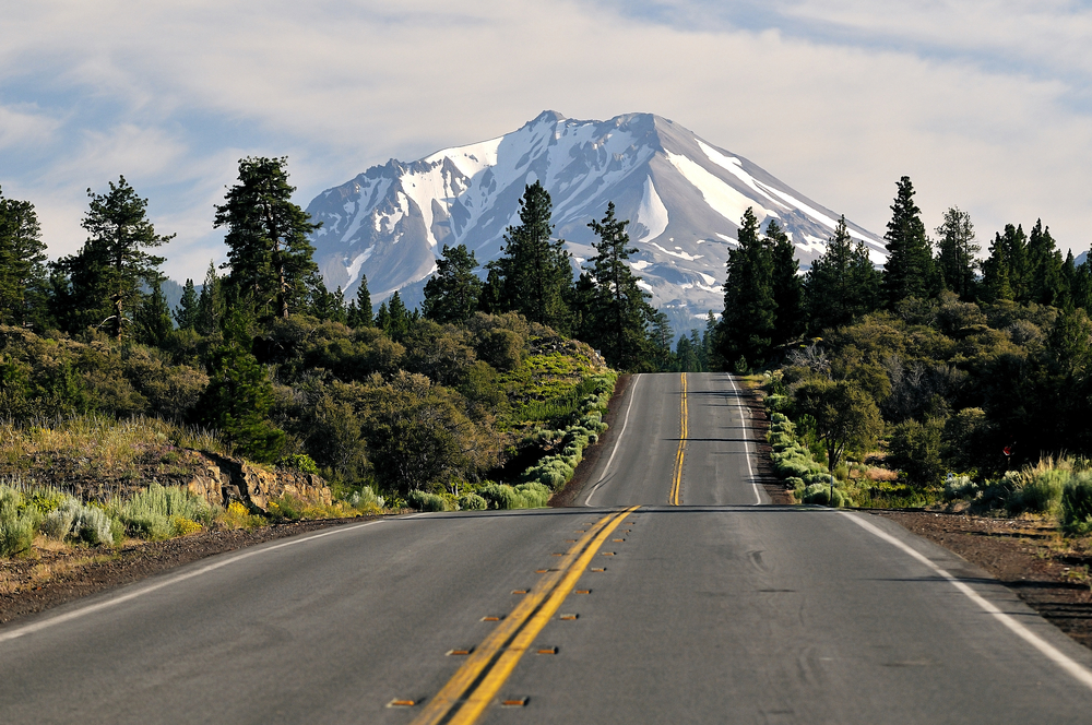 Empty highway leading to snowy Mount Shasta in Northern California.
