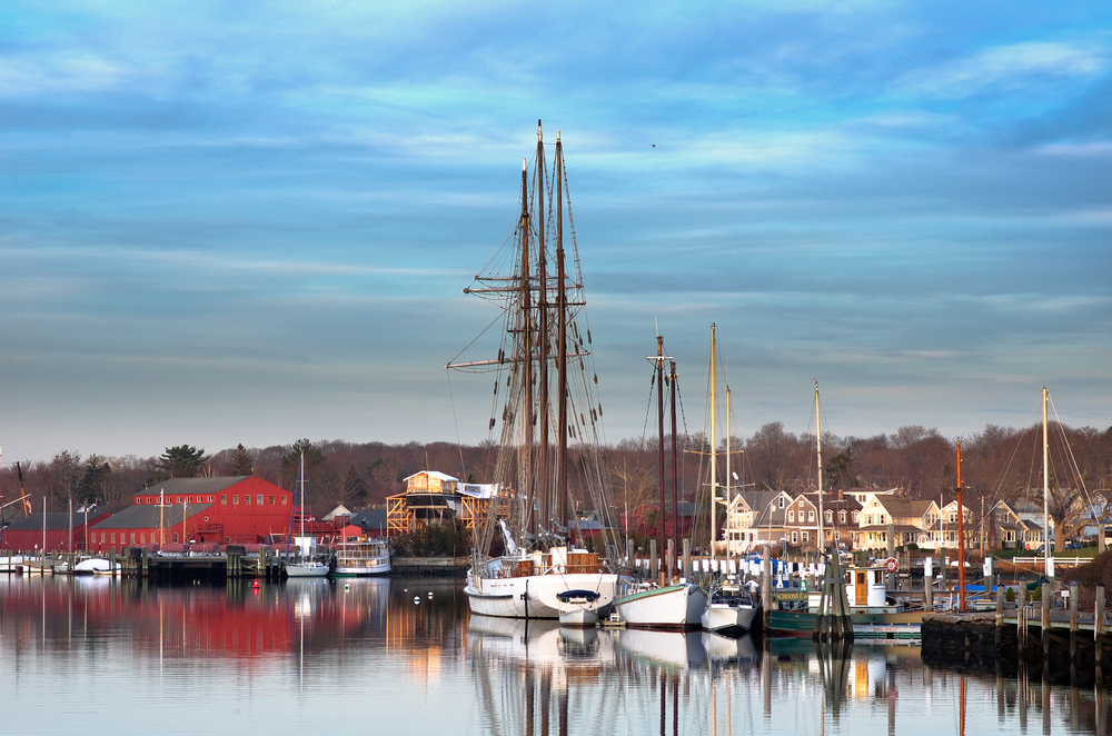 The marina in Mystic, Connecticut, on a cloudy day with many docked sailboats.