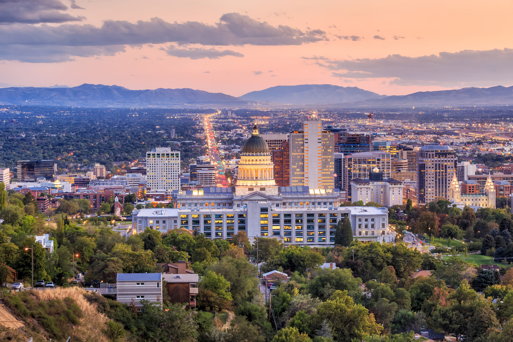 Pastel sunset over Salt Lake City with the state capitol building and mountains in the distance.