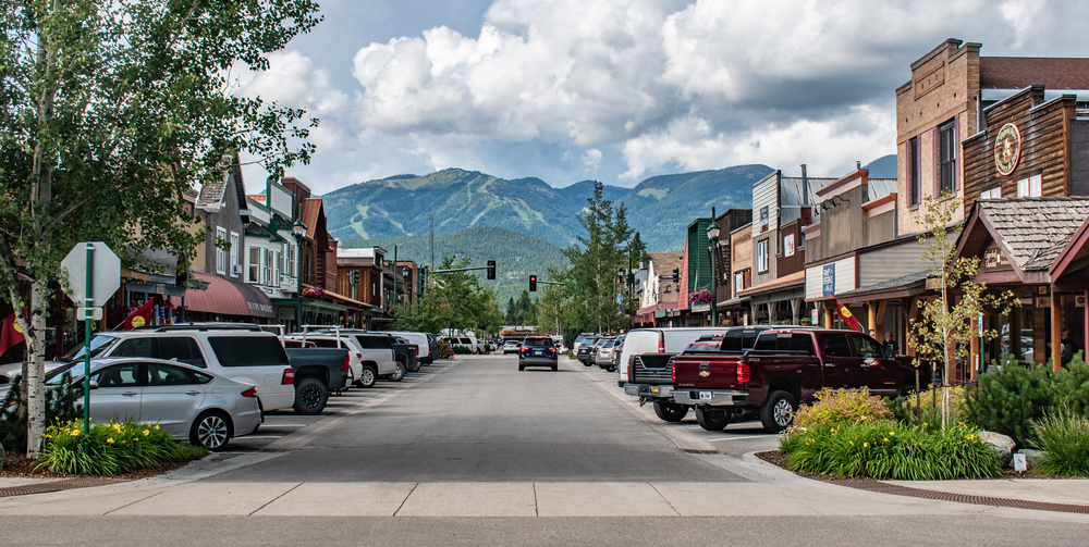View of downtown Whitefish with historic buildings and mountains in the distance.