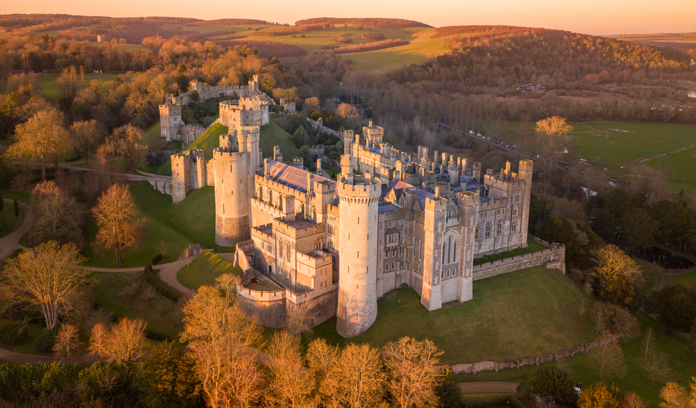 Bird Eye View of one of the castles in England with a wonderful sunset light. You can see the whole of the castle surrounded by fall trees. 