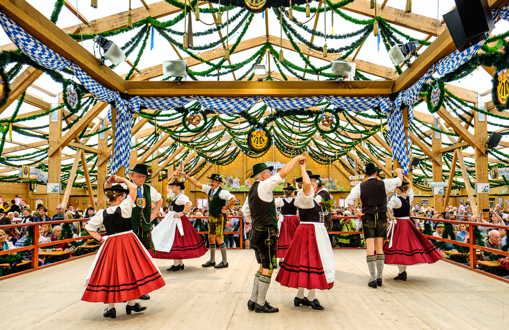 couples are dancing at Oktoberfest in munich germany, one of the best places to visit in europe in september 