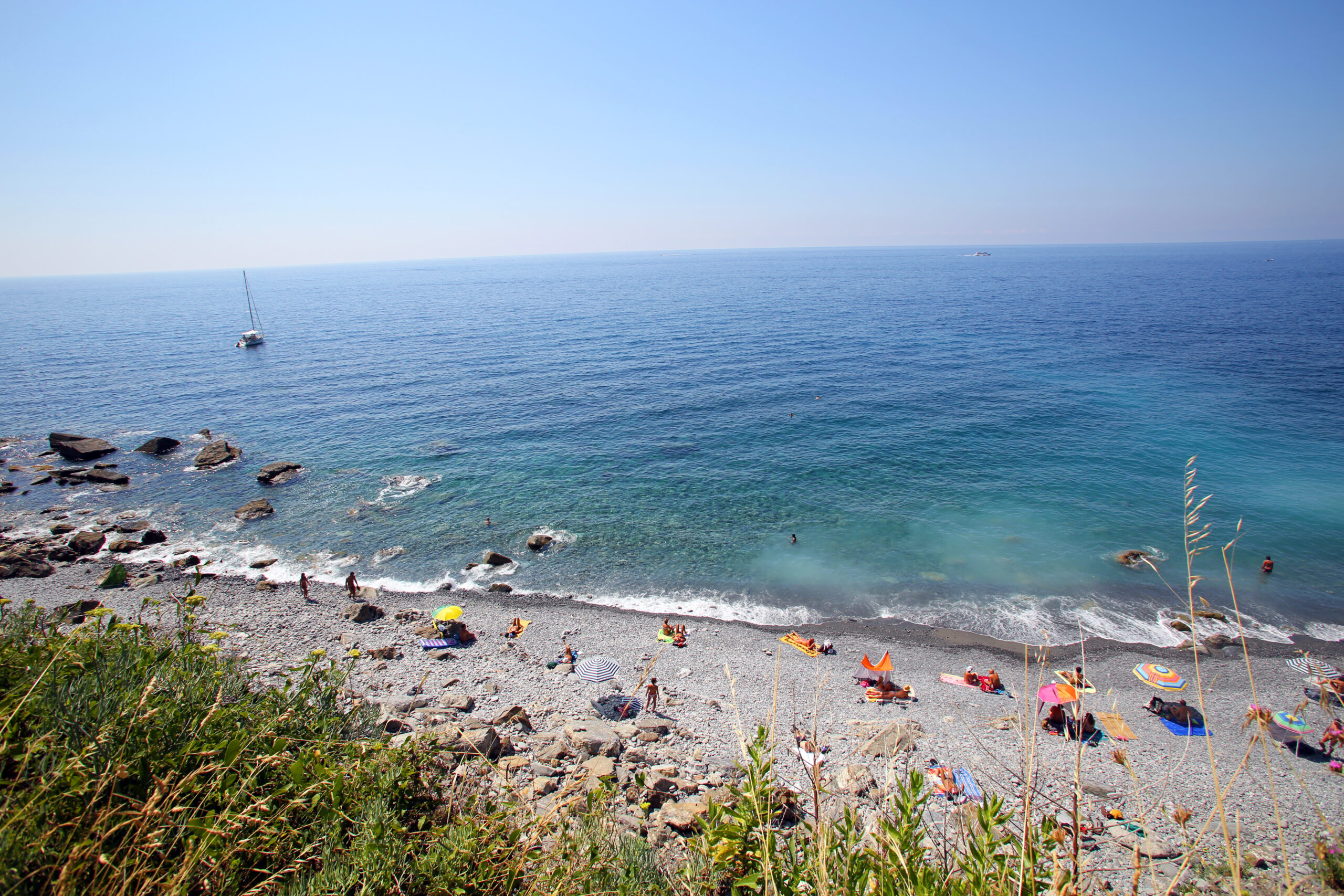 Stunning and remote Guavano Beach with only a handful of sunbathers and one sailboat visible