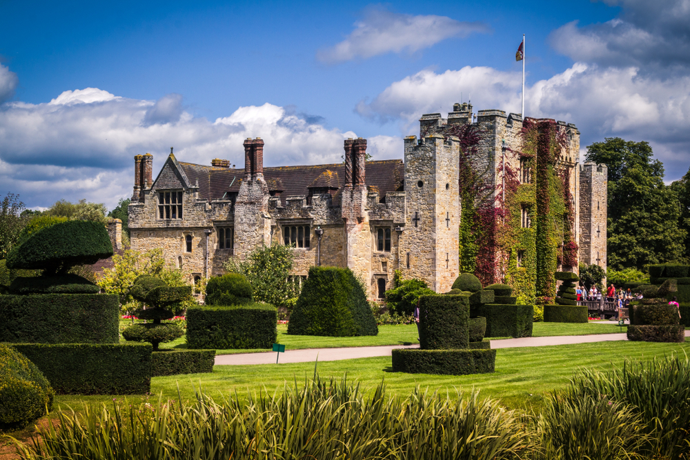 One of the castles near London. There are hedges out the front and the building is covered in ivy.  