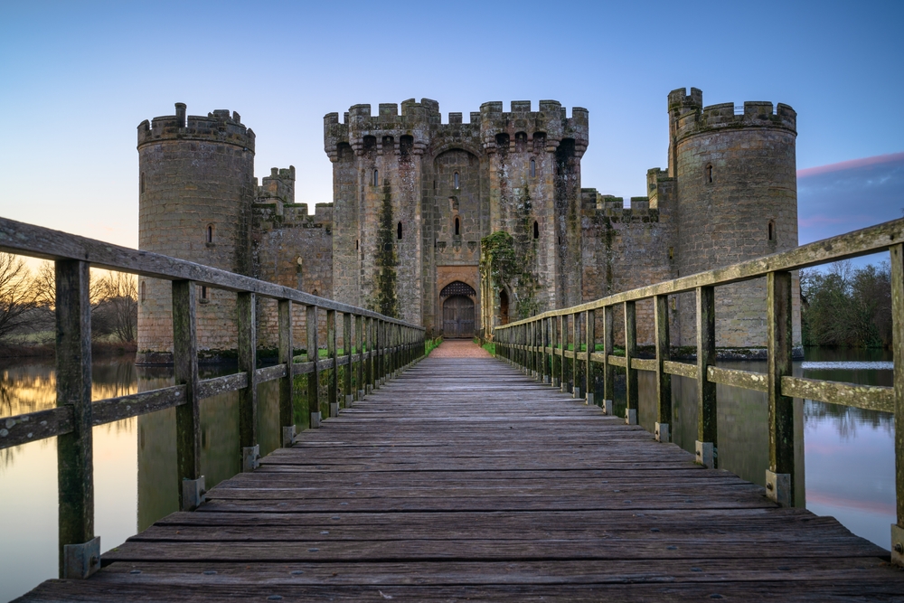 Ruins of 14th century Bodiam castle at sunrise. You can see the bridge leading to the entrance gate. 