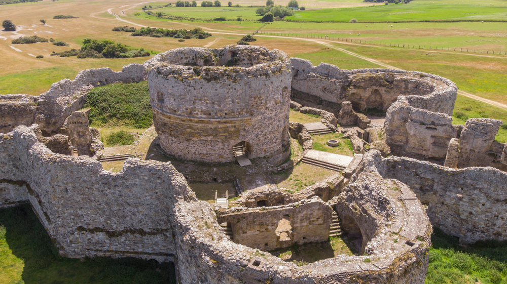 Castle ruins showing one of the castles near London. The photo is taken from the air and you can see the fields surrounding it. 