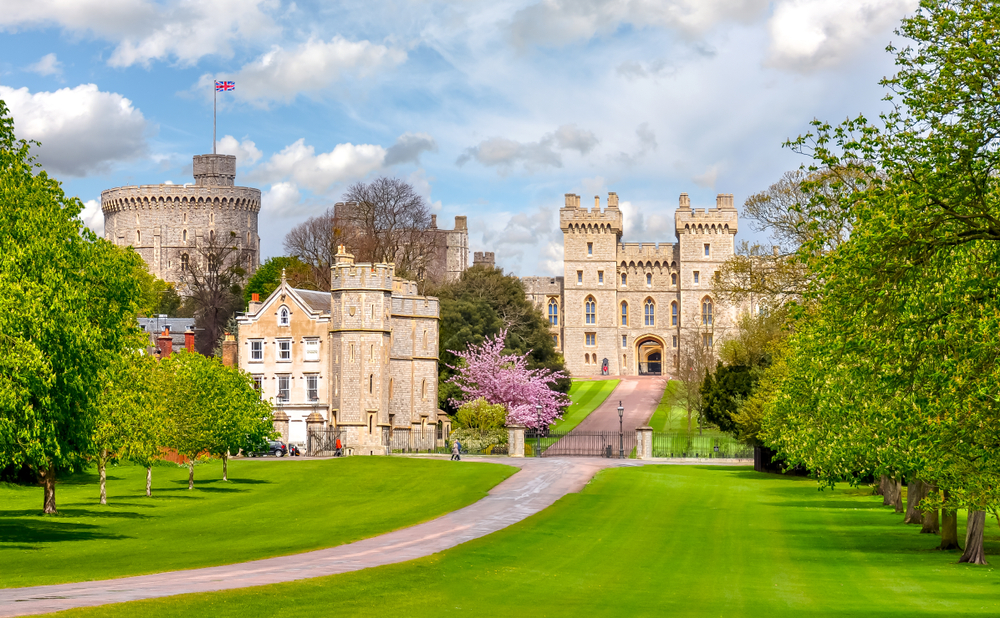 Long walk to Windsor castle in spring. The castle is at the end of a road and you can see spring flowers. 