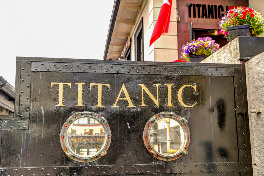 Memorial and signage relating to the Titanic disaster. It is a black plaque with words on it. 