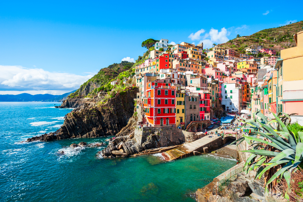 Riomaggiore showing the town and the rocks surrounding the village and the harbor.  
