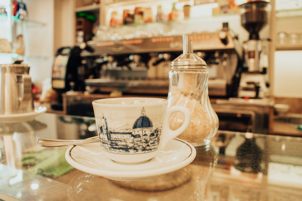 a cup of coffee at a florence cafe with printed duomo on the cup