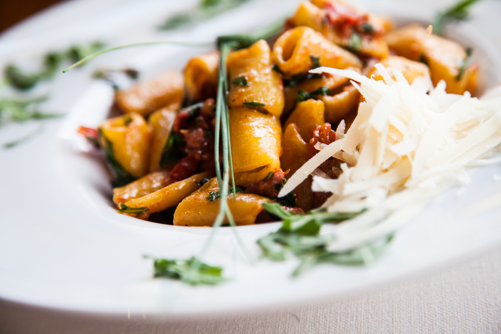 a bowl of pasta topped with cheese