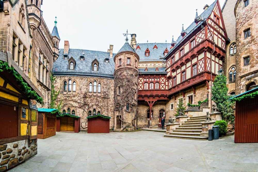 Wernigerode castle you can see the ornate walls and it is around a square. One of the small towns in Germany. 