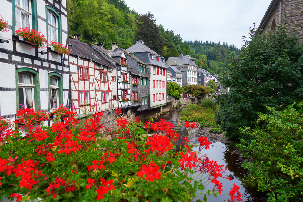 Old half timbered houses at the river Rur in the picturesque Eifel town Monschau in Western Germany