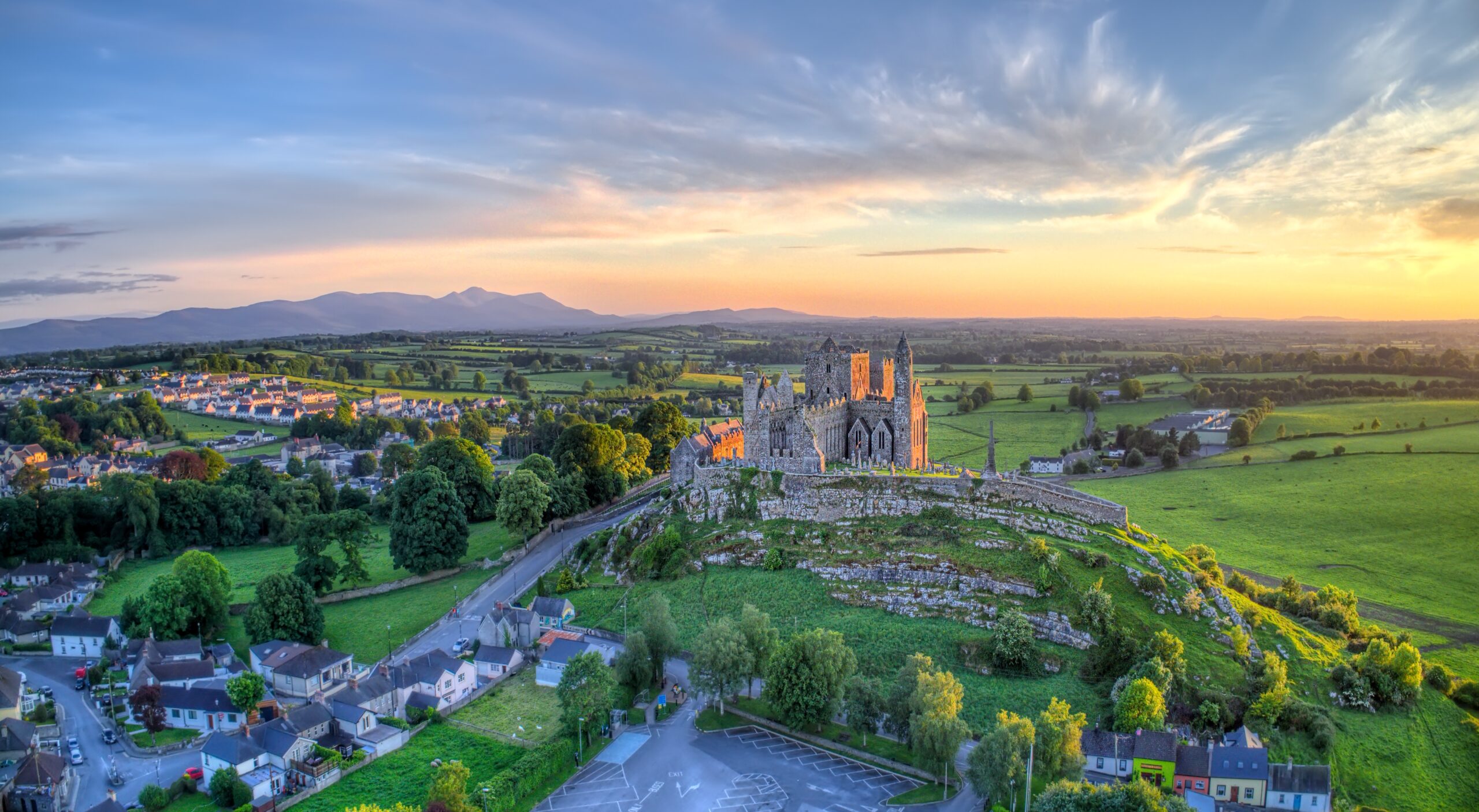 The rock of Cashel on a hill overlooking Cashel town at sunset 