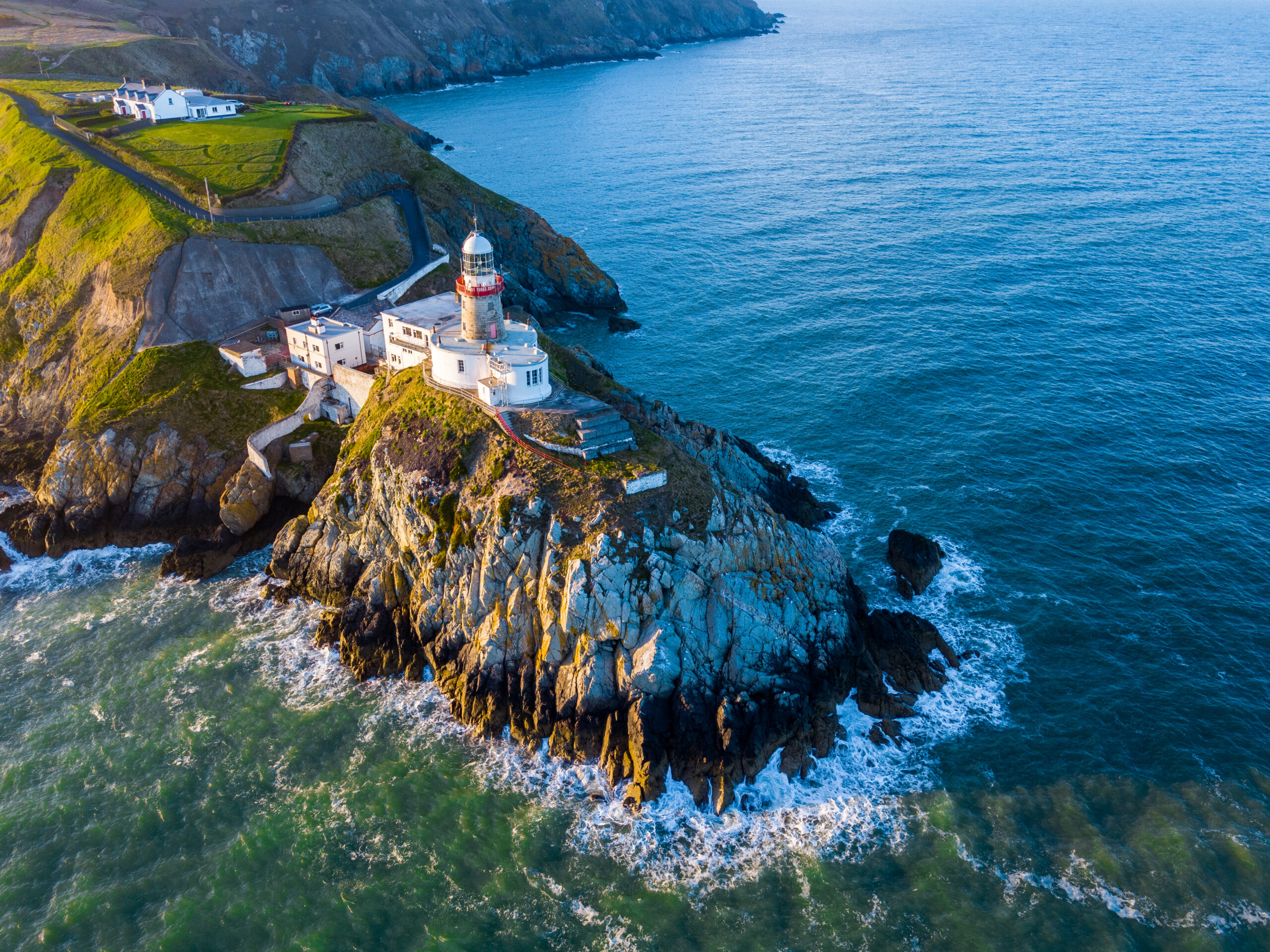 Aerial view of the famous cliff walk and beautiful lighthouse in Howth, Ireland