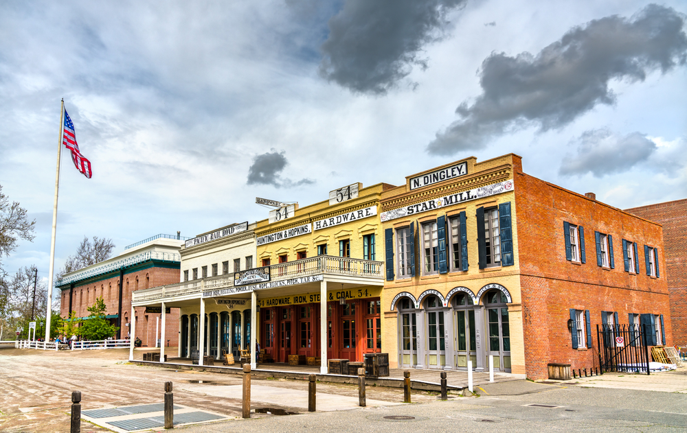 A line of Gold Rush-era buildings in Old Sacramento Historic District on a cloudy day.