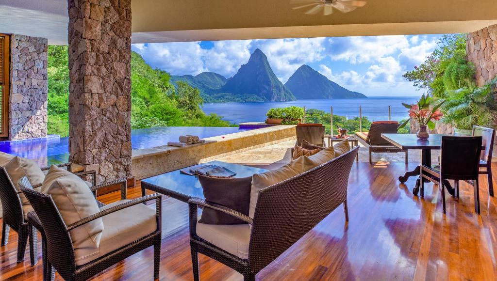 View from a hotel room to the mountains and ocean below. The room has a pool and a large open deck. It is one of the best adults only all inclusive resorts. 