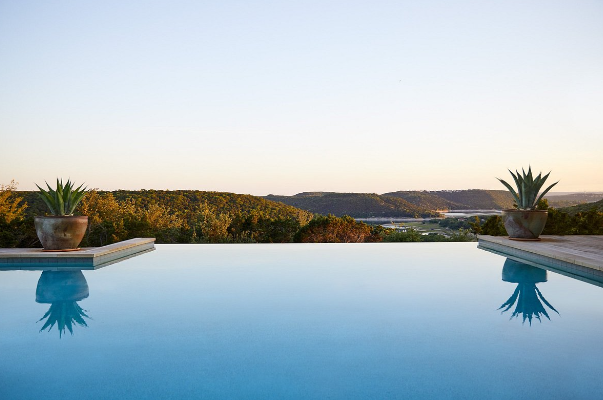 Swimming poll with hills in the background. 