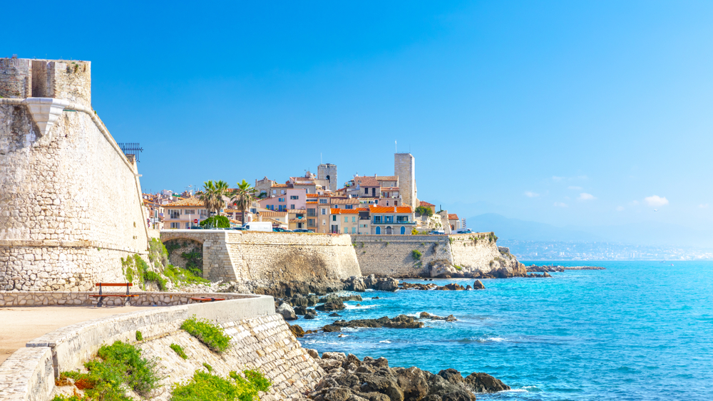 Historic center of Antibes, French Riviera, Provence, France. You can see the walls and the town and the bright blue sea. It is one of the best beach towns in Europe. 