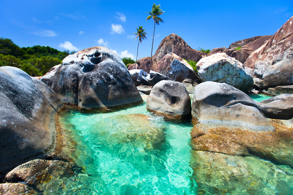 Granite boulders surround a crystalline pool at the Baths in the British Virgin Islands, one of the best beaches in the Caribbean. 