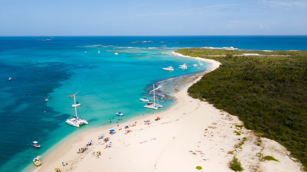 Aerial view of the turquoise Caribbean waters and white sand beach of Cayo Icacos in Puerto Rico. 