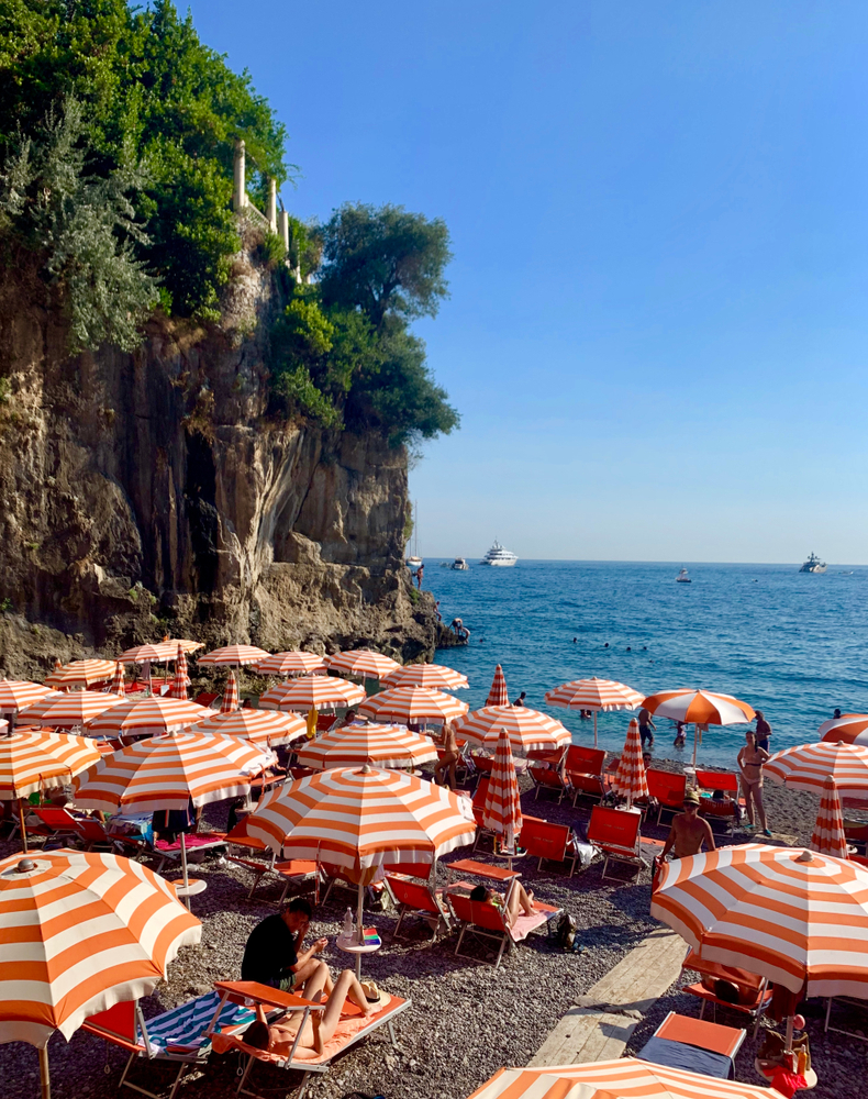 The orange and white stripped umbrellas at the Arizeno beach Cub