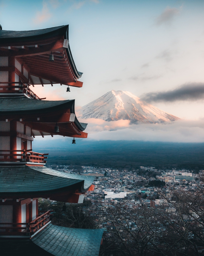 Landscape of Kyoto with Japanese temples. You can see a mountain in the background. 